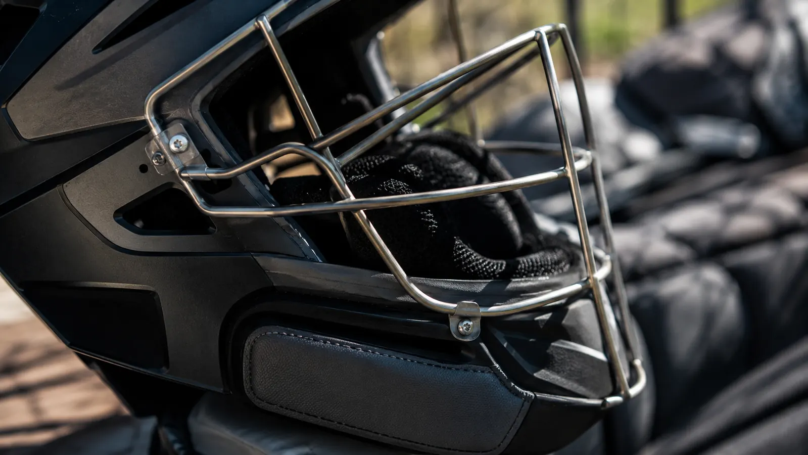 Close-up of the catcher's helmet mask hinge and chin strap padding